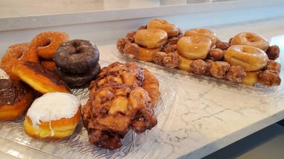 A variety of freshly baked donuts on display.