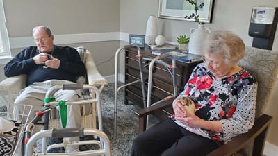 Residents enjoying time together with a pet.