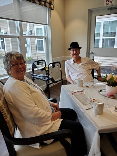 Two smiling residents in a common area
