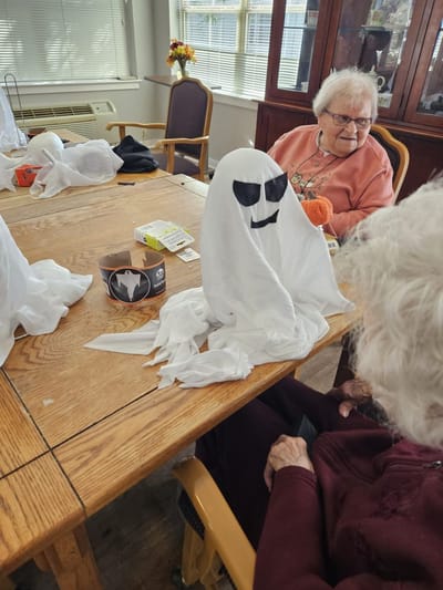 Residents engaging in a Halloween craft activity.