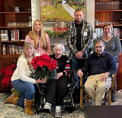 Residents and staff celebrate with holiday plants.