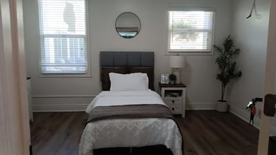 A private resident room featuring a single bed and decor