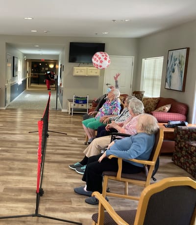 Residents participating in a recreational activity indoors.