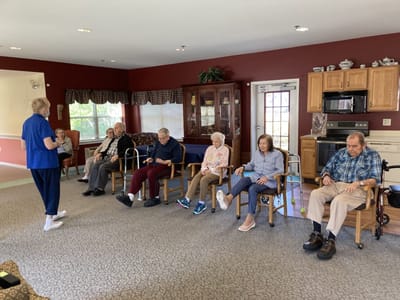 Residents participating in a group activity indoors.
