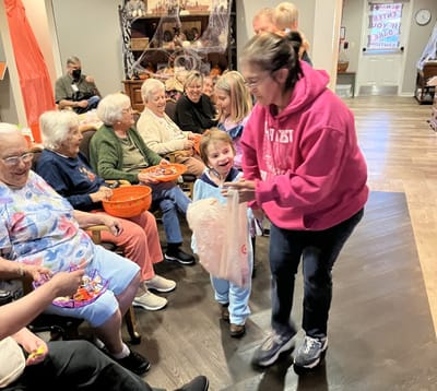 Residents and children engaged in an activity together.