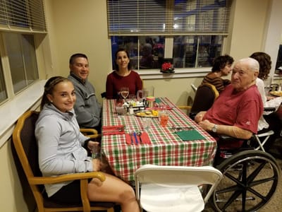 Residents and family enjoying dinner together