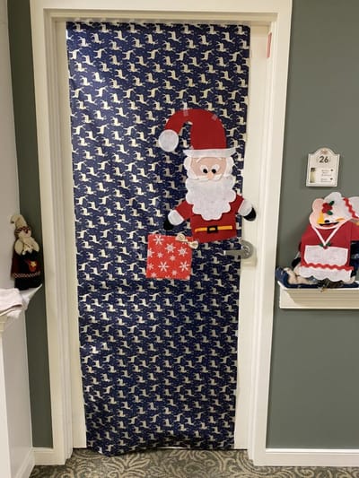 Festively decorated door with holiday theme.
