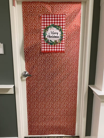Decorated door with a Christmas wreath
