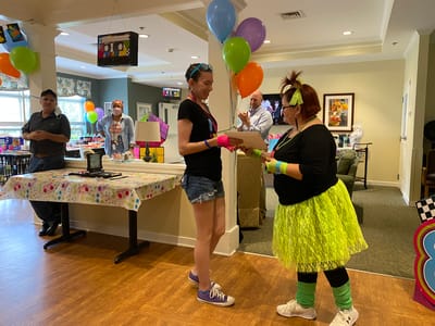 Residents and staff celebrating at a colorful event