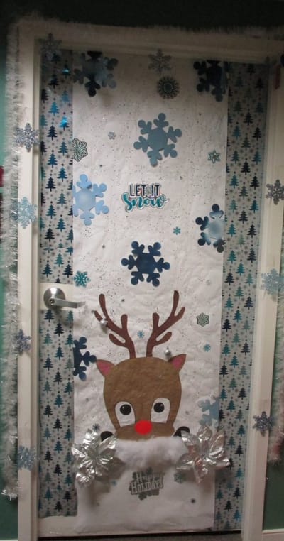 Festive holiday door decoration with reindeer theme.