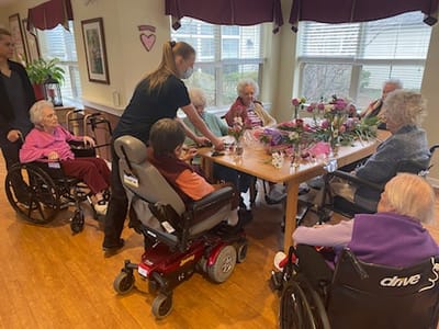 Residents and staff engaged in a floral activity