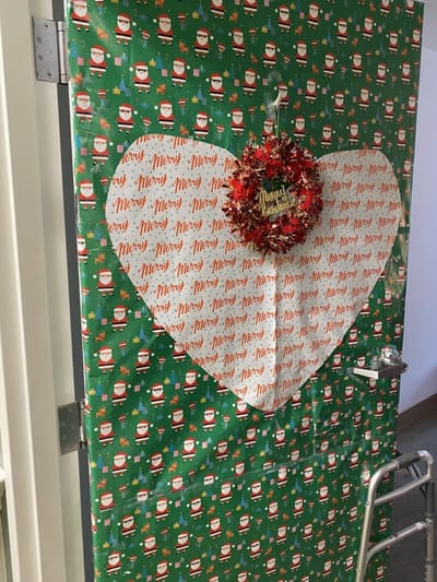 Christmas-decorated door with a heart cutout