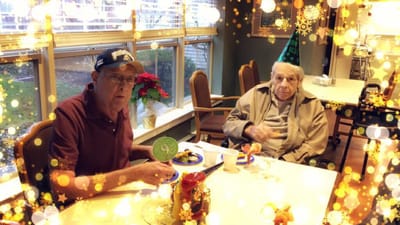 Two elderly men enjoying a meal together