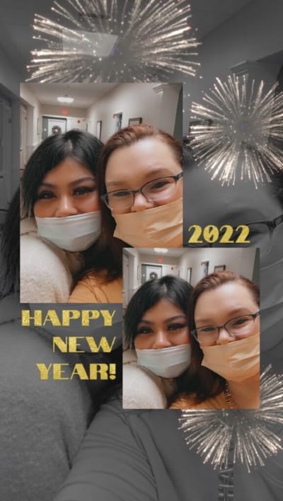 Two women celebrating New Year in a hallway.