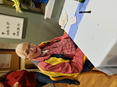 Resident enjoying a social moment at a table.