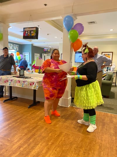 Residents enjoying a lively celebration indoors.