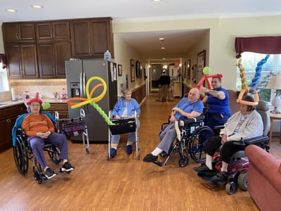 Residents enjoying a balloon activity in a common area