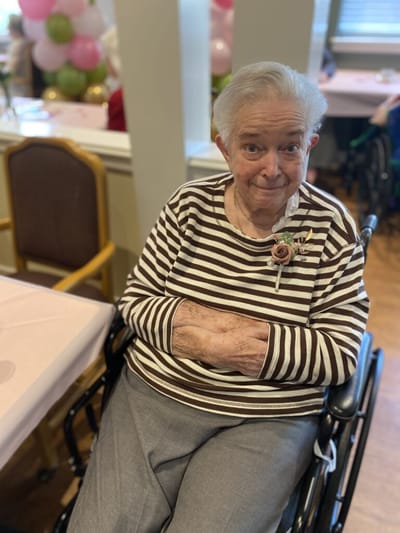 Senior woman smiling in a common area.