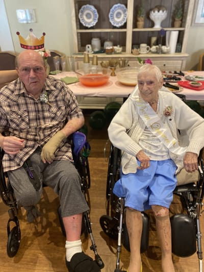 Two residents celebrating in a common area.