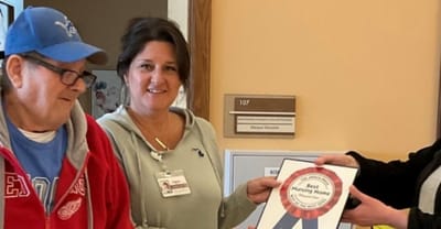 Staff member presenting an award to a resident.