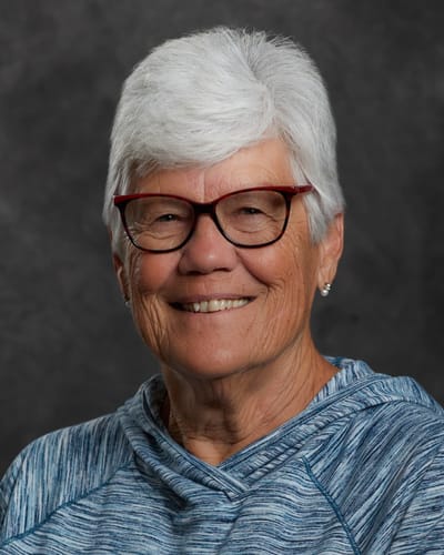 Smiling older woman with glasses and silver hair
