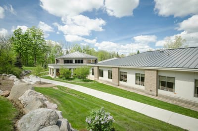 Exterior view of a nursing home facility surrounded by greenery.
