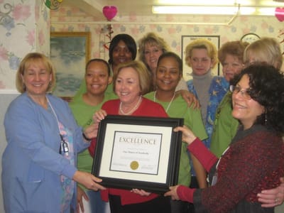 Staff celebrating an award presentation
