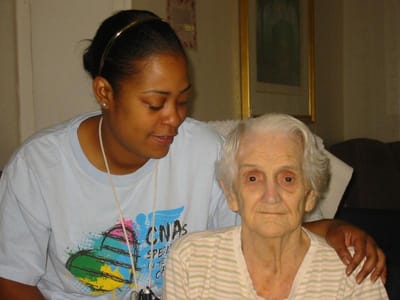 Caregiver assisting a senior resident.