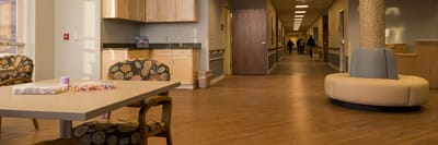 Interior common area with furniture and residents.
