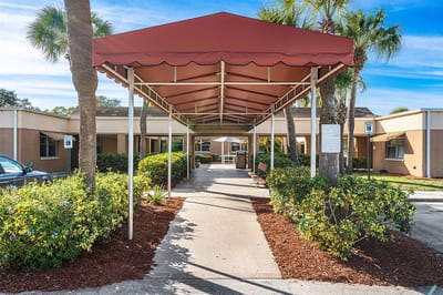 Entrance with canopy and landscaped pathway