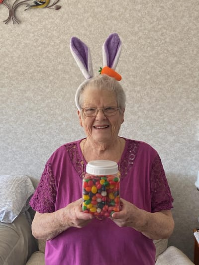 Resident in bunny ears holding a jar of jelly beans