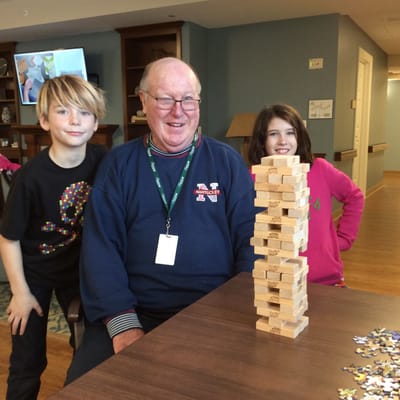 Residents playing Jenga in an activity room