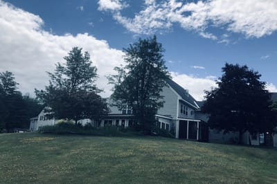 Exterior view of The Golden Crest building surrounded by greenery