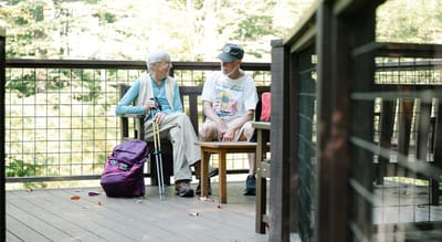 Two residents enjoying time on a deck.