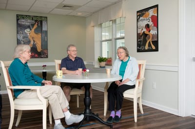 Residents chatting in a common area with artwork