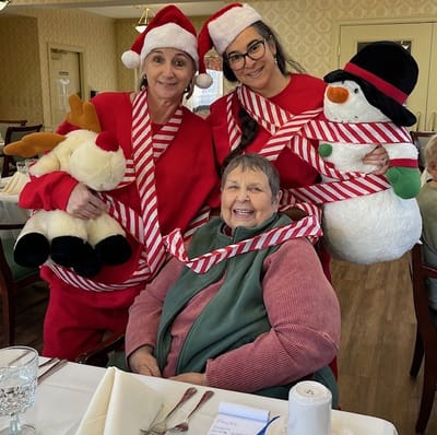 Residents and staff celebrating with holiday decorations