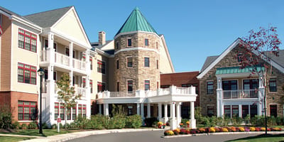 Exterior view of a senior care facility with gardens