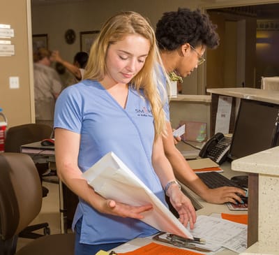 Staff members working at a reception desk