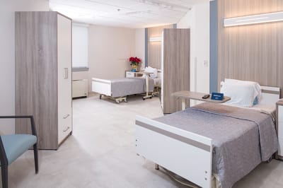 Two beds in a well-lit resident room