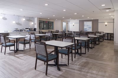Bright spacious dining room with tables and chairs
