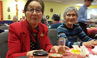 Two elderly women enjoying a meal together