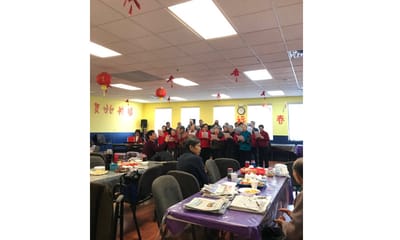 Residents participating in a singing activity in a common area