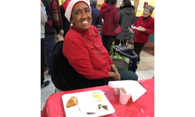 Resident enjoying a festive meal in the dining area