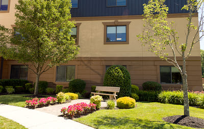 Exterior view of a senior living facility with landscaping