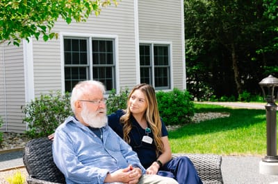 A resident and staff member enjoying time outdoors
