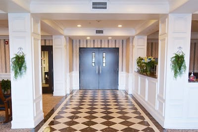 Interior lobby area with patterned flooring and double doors