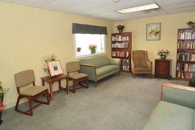 Cozy common area with seating and bookshelves