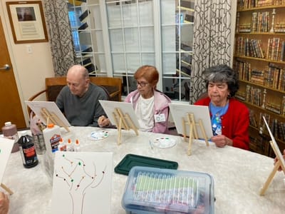 Residents engaged in a painting activity together