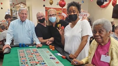 Residents and staff enjoying a gaming event in a common area