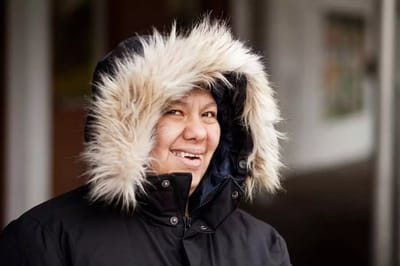 Smiling woman in a warm coat with fur trim
